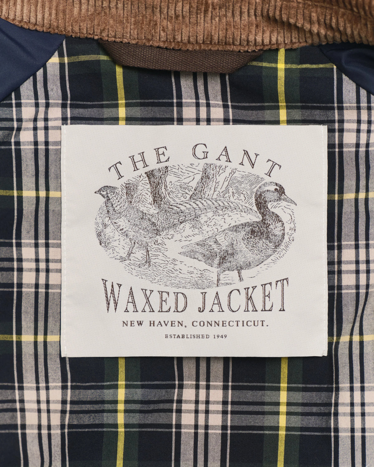 Waxed herr jacka med rutigt foder och etikett med fågelmotiv – herr jacka