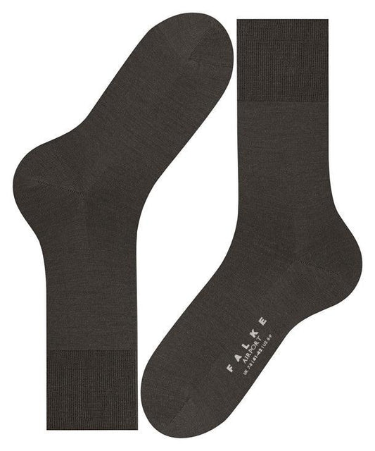 Mörkgrå herrstrumpor i merinoull, klassisk design, texten FALKE Airport synlig på foten