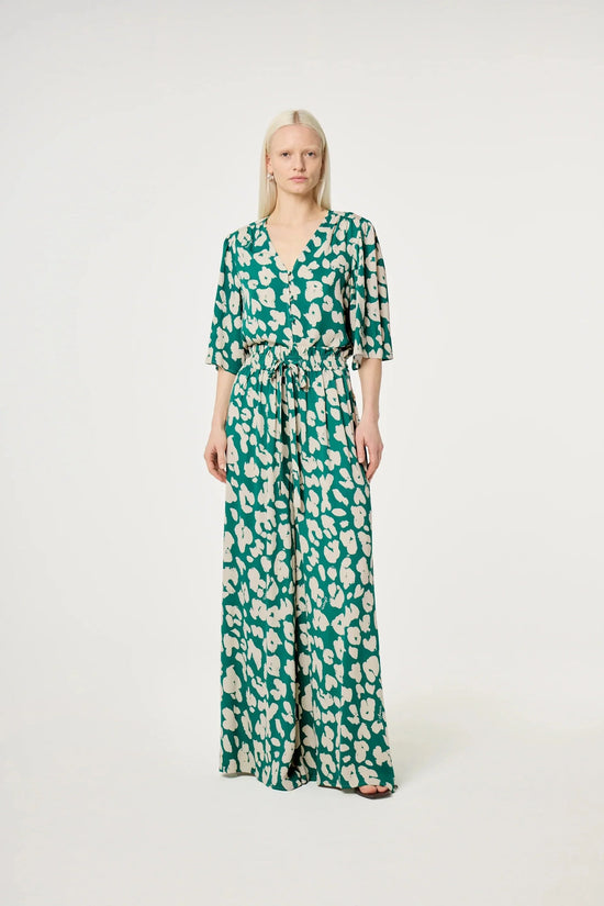 Grön och vit mönstrad jumpsuit med v-ringning och knyt i midjan dam