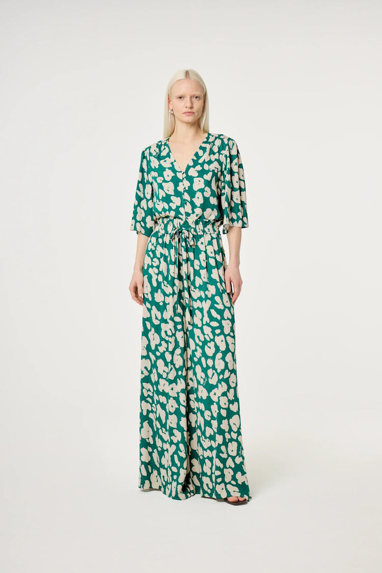 Grön och vit mönstrad jumpsuit med v-ringning och knyt i midjan dam