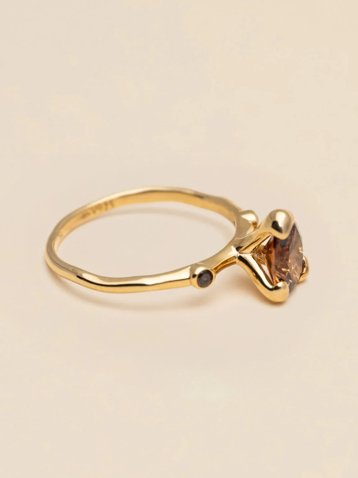 Elegant guldring med brun sten och smal design, minimalistiskt herraccessoar