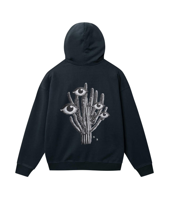 Desert Trip Boxy Hood svart hoodie med grafiskt kaktusmotiv och ögon bak