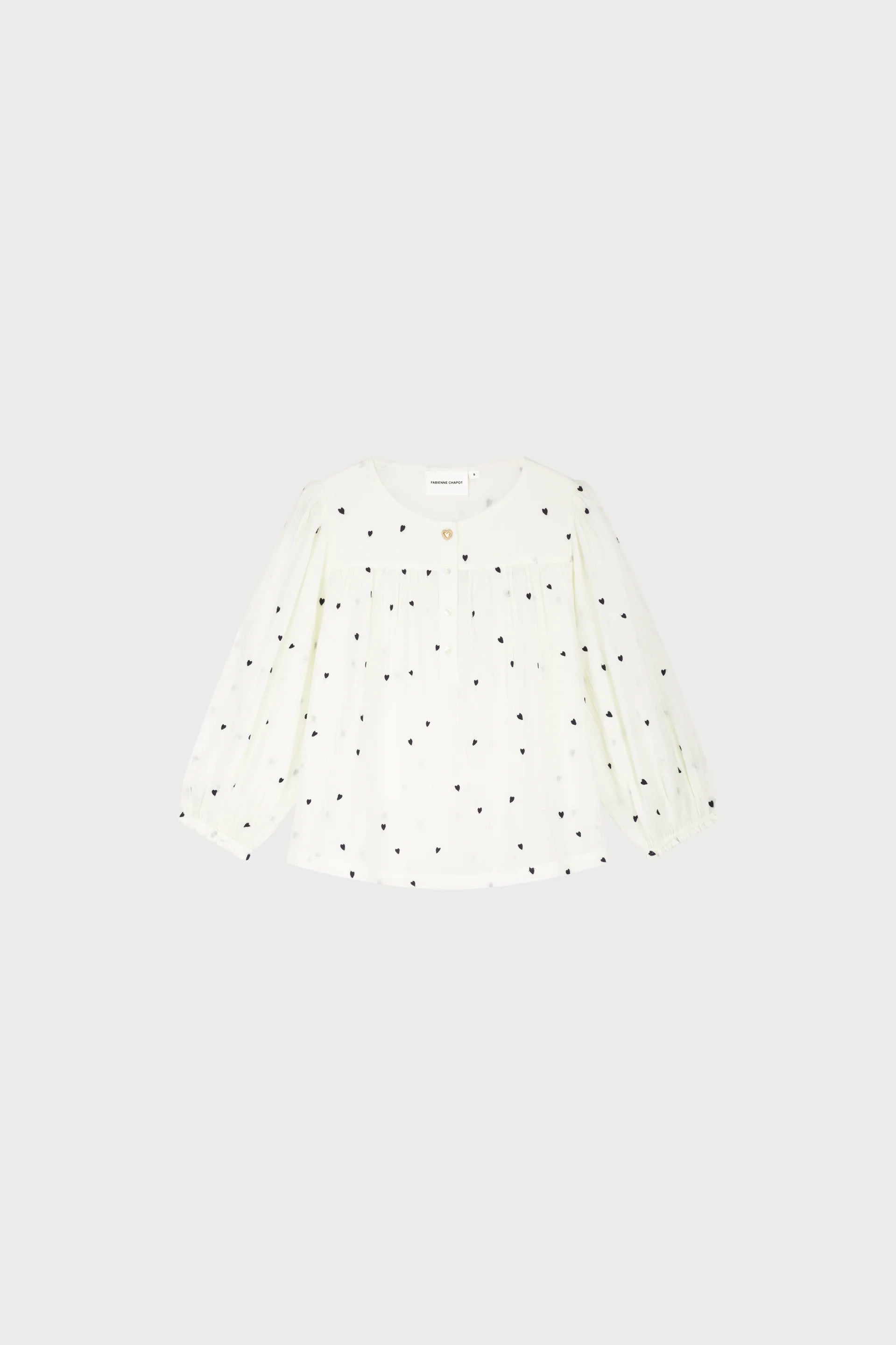 Bindi Top vit blus med svarta hjärtmönster och lång ärm