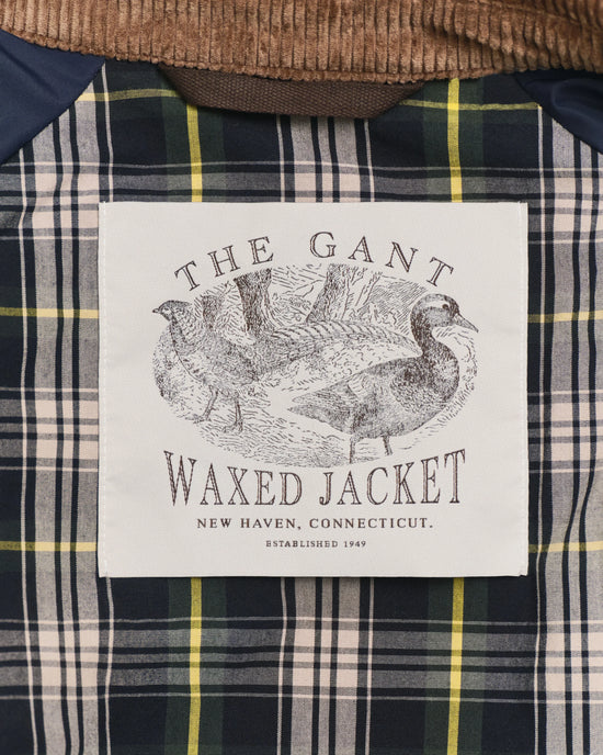 Waxed herr jacka med rutigt foder och etikett med fågelmotiv – herr jacka